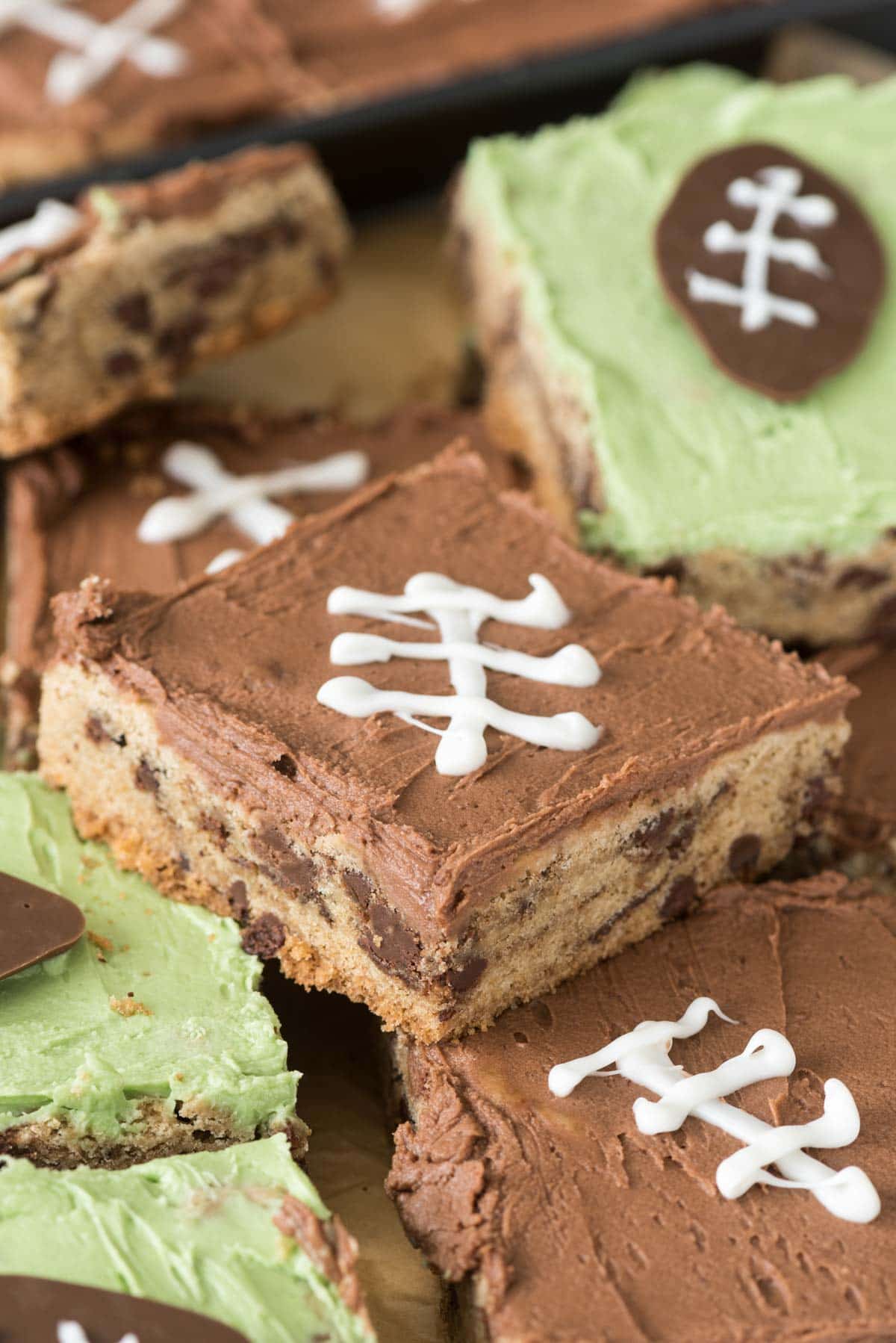 Mega Chocolate Chip Cookie Cake frosted for football season! This easy cookie recipe makes a TON so it's perfect for a party.