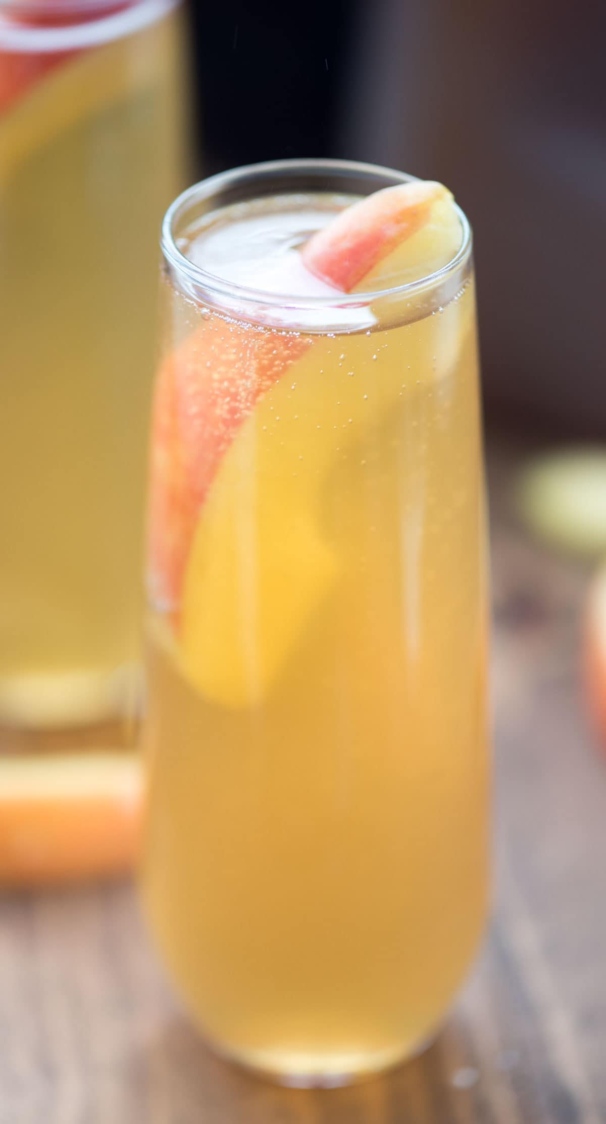 Champagne glass of Apple Cider Mimosa on a wooden table. 