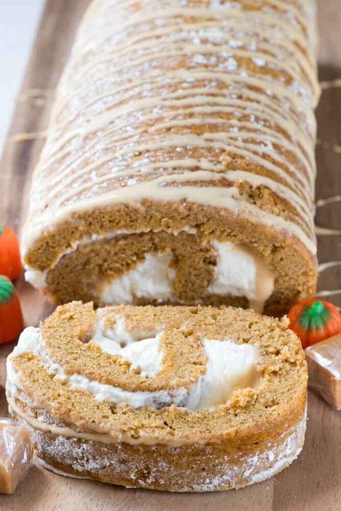 Caramel Pumpkin Cake Roll - an easy pumpkin roll cake filled with caramel ganache and cream cheese whipped cream. This is the BEST pumpkin roll recipe!