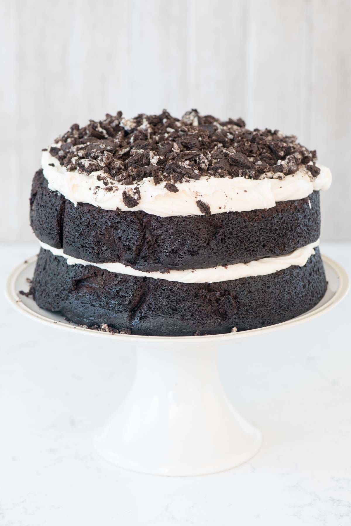 Extreme Cookies 'n Cream Cake - this cake tastes like an Oreo cookie! Dark chocolate cake layers sandwiched with a marshmallow buttercream frosting and lots of crushed Oreo cookies.