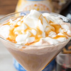 mocha martini in martini glass with whipped cream and caramel