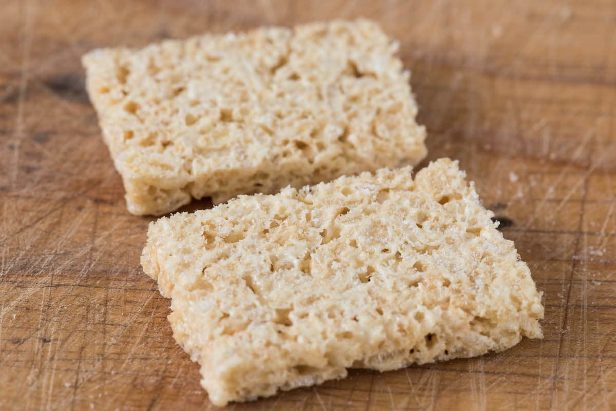 rice krispie treat cut in half on cutting board