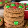 stack of molasses cookies with christmas m&ms