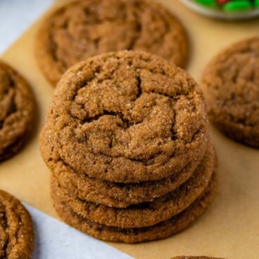 STACK OF 4 MOLASSES COOKIES on brown parchment