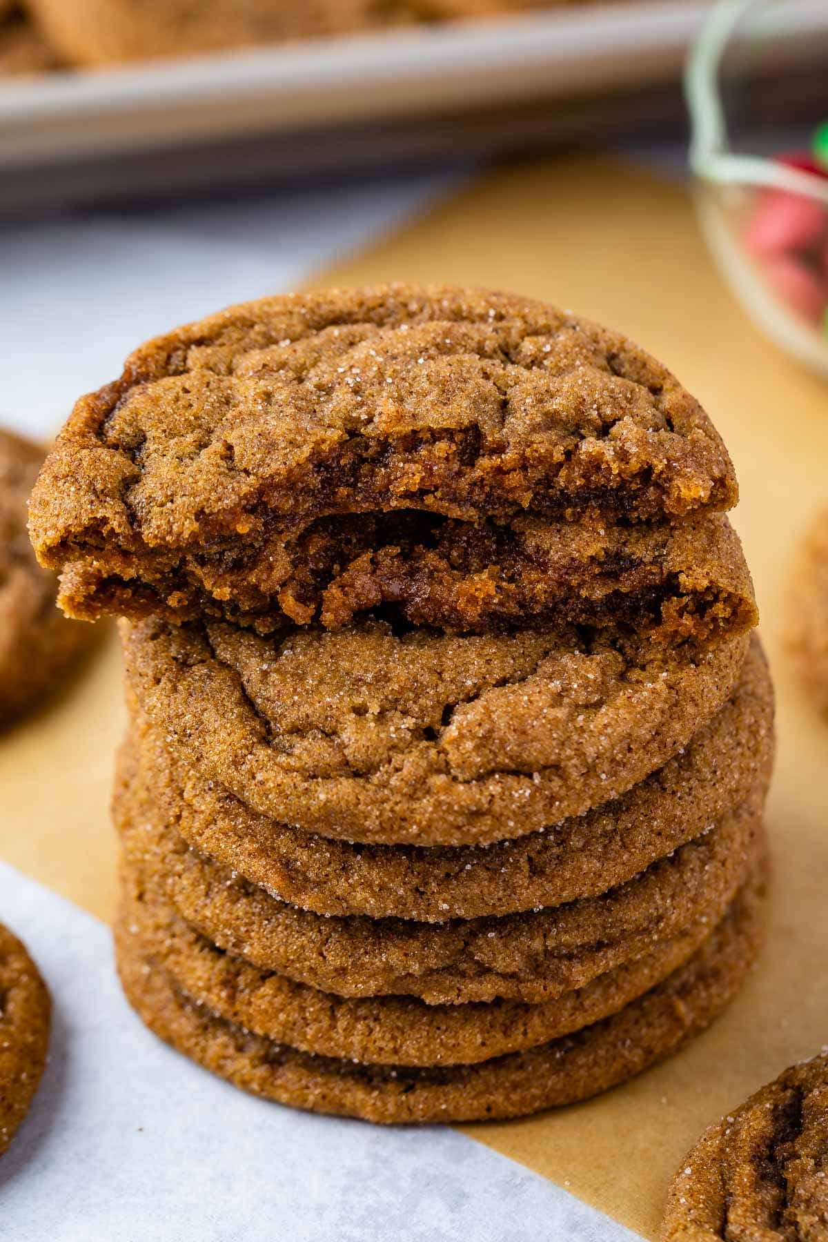 STACK OF 4 MOLASSES COOKIES on brown parchment with cookie halves on top of stack