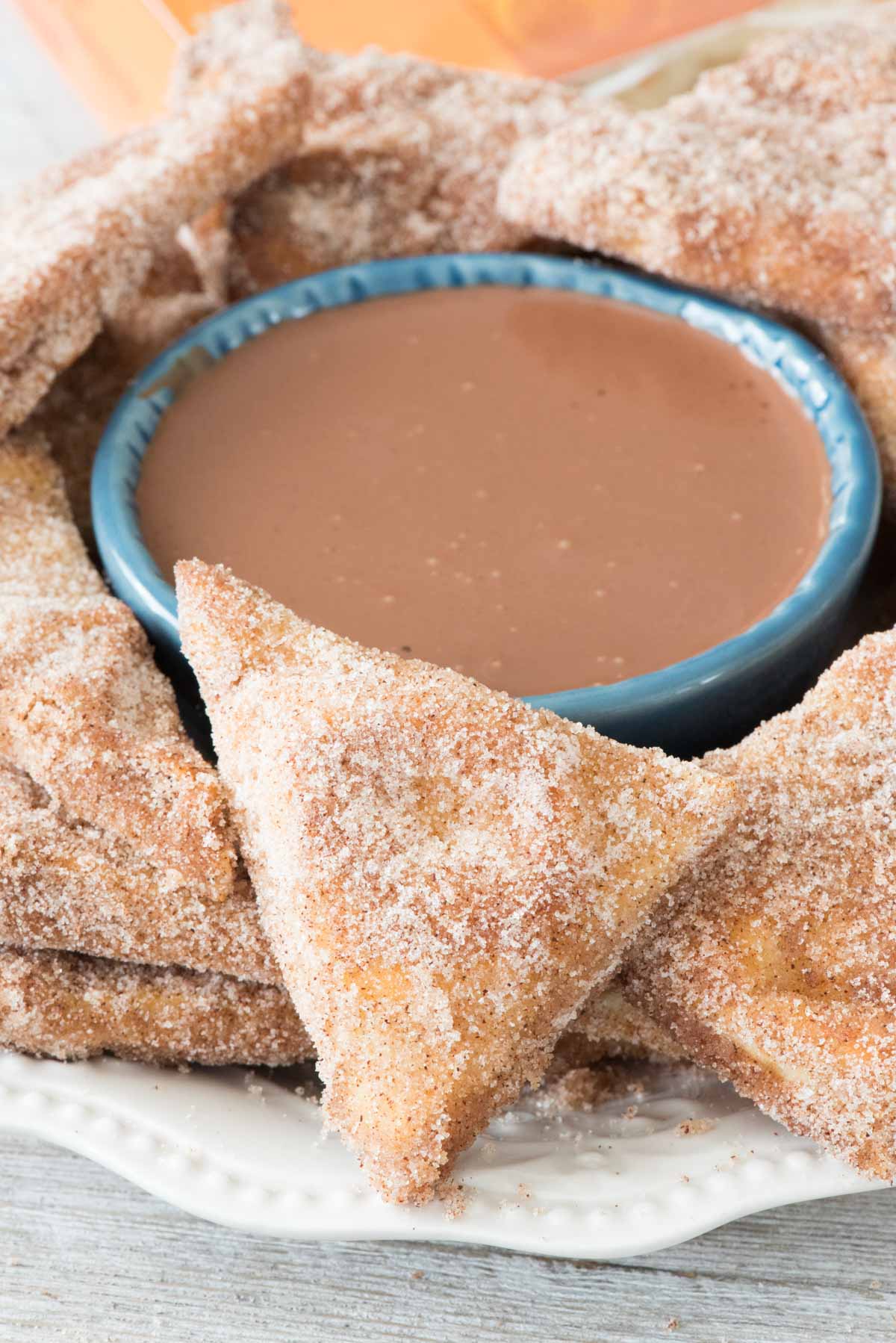 Baked Churro Chips with chocolate ganache dip - this EASY recipe starts with naan and becomes a crunchy churro chip, best dipped in rich chocolate ganache dip!