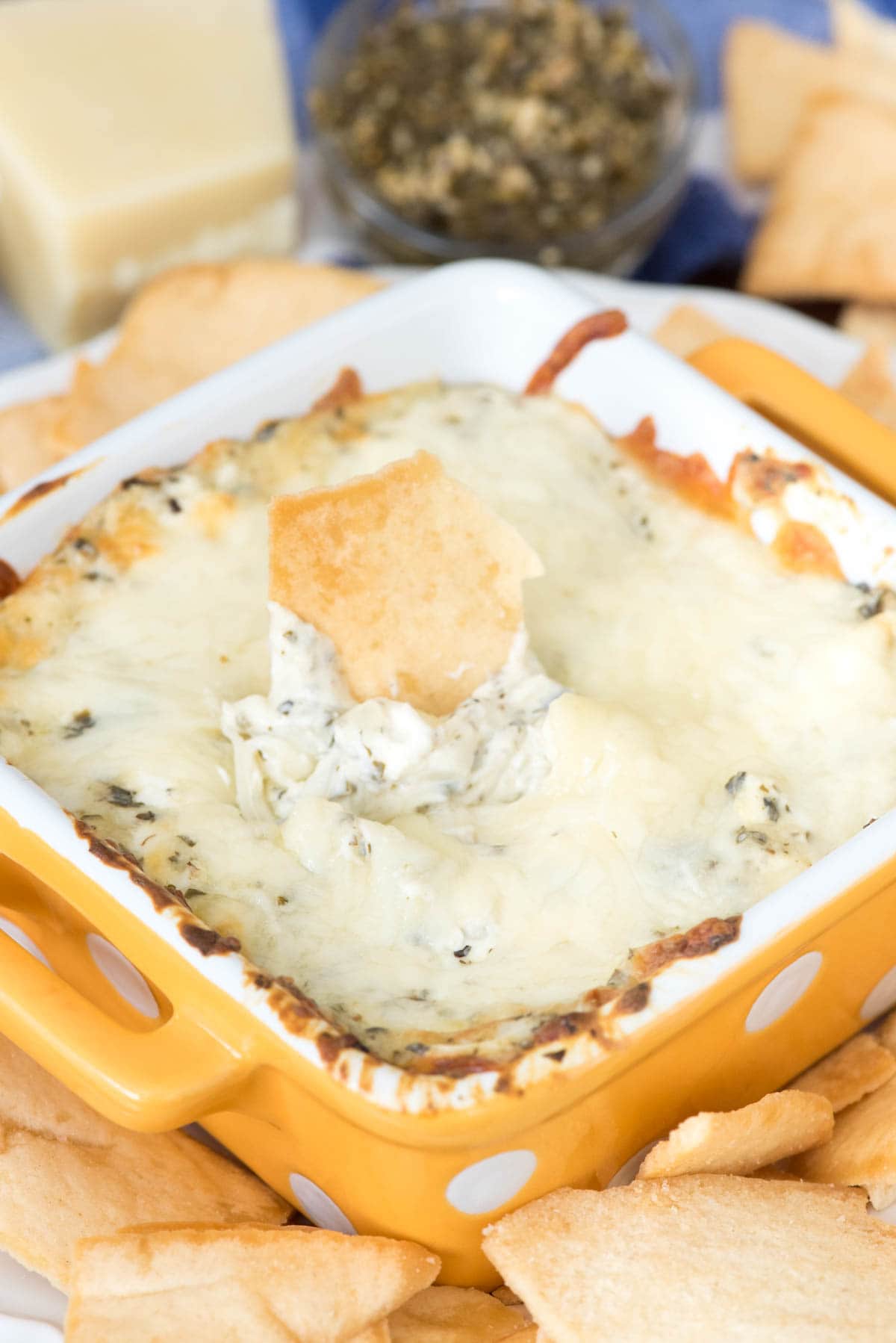 Hot Cheesy Pesto Dip - this super EASY appetizer is the perfect dip! Just 5 ingredients make a gooey cheesy dip full of basil and garlic pesto flavor!