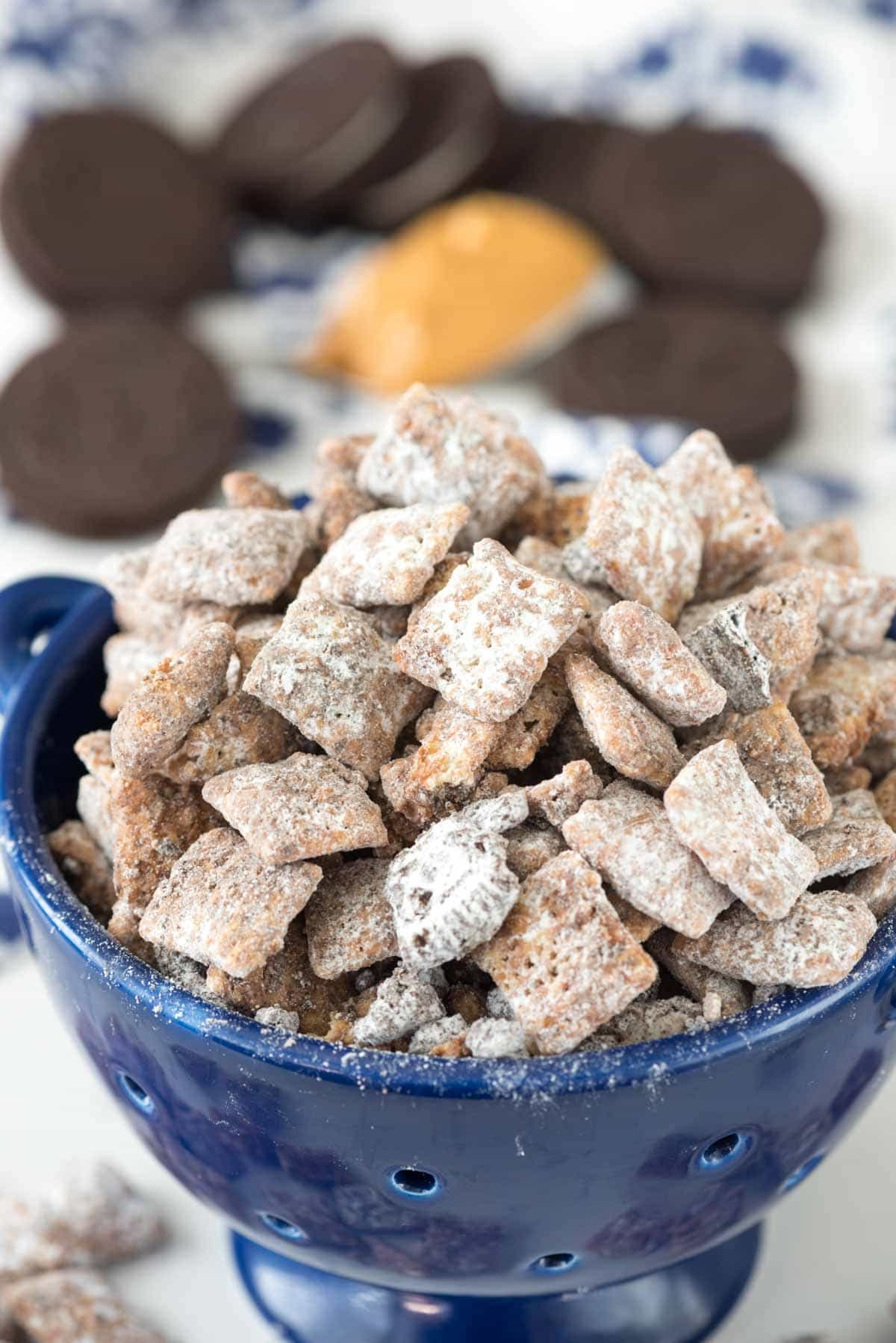 Peanut Butter Cookies 'n Cream Muddy Buddies - this easy puppy chow recipe adds crushed Oreos to the topping! Who knew you could improve on the muddy buddy recipe?