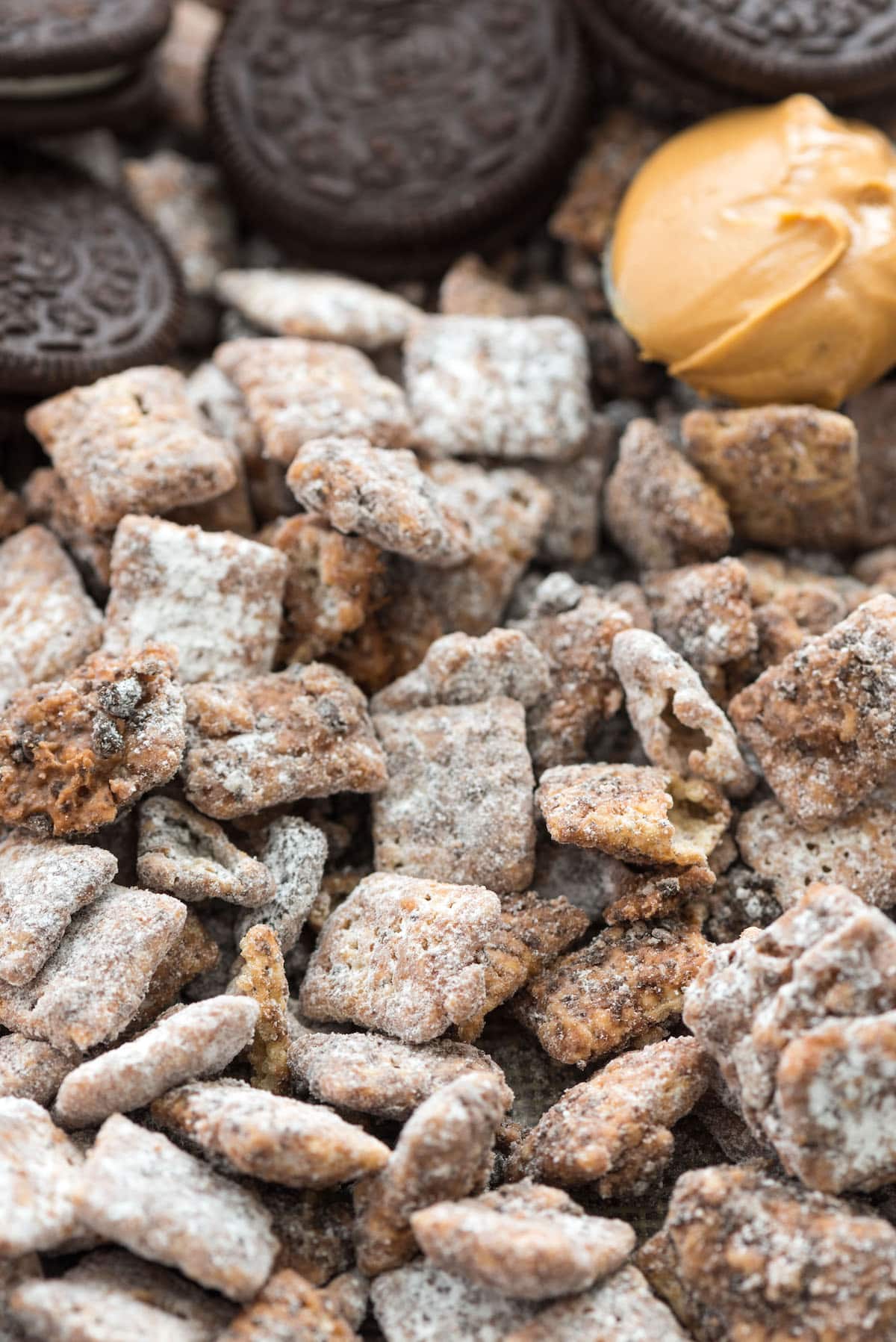 muddy buddies with oreos and peanut butter on cookie sheet