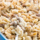 Sausage macaroni and cheese in a blue casserole dish