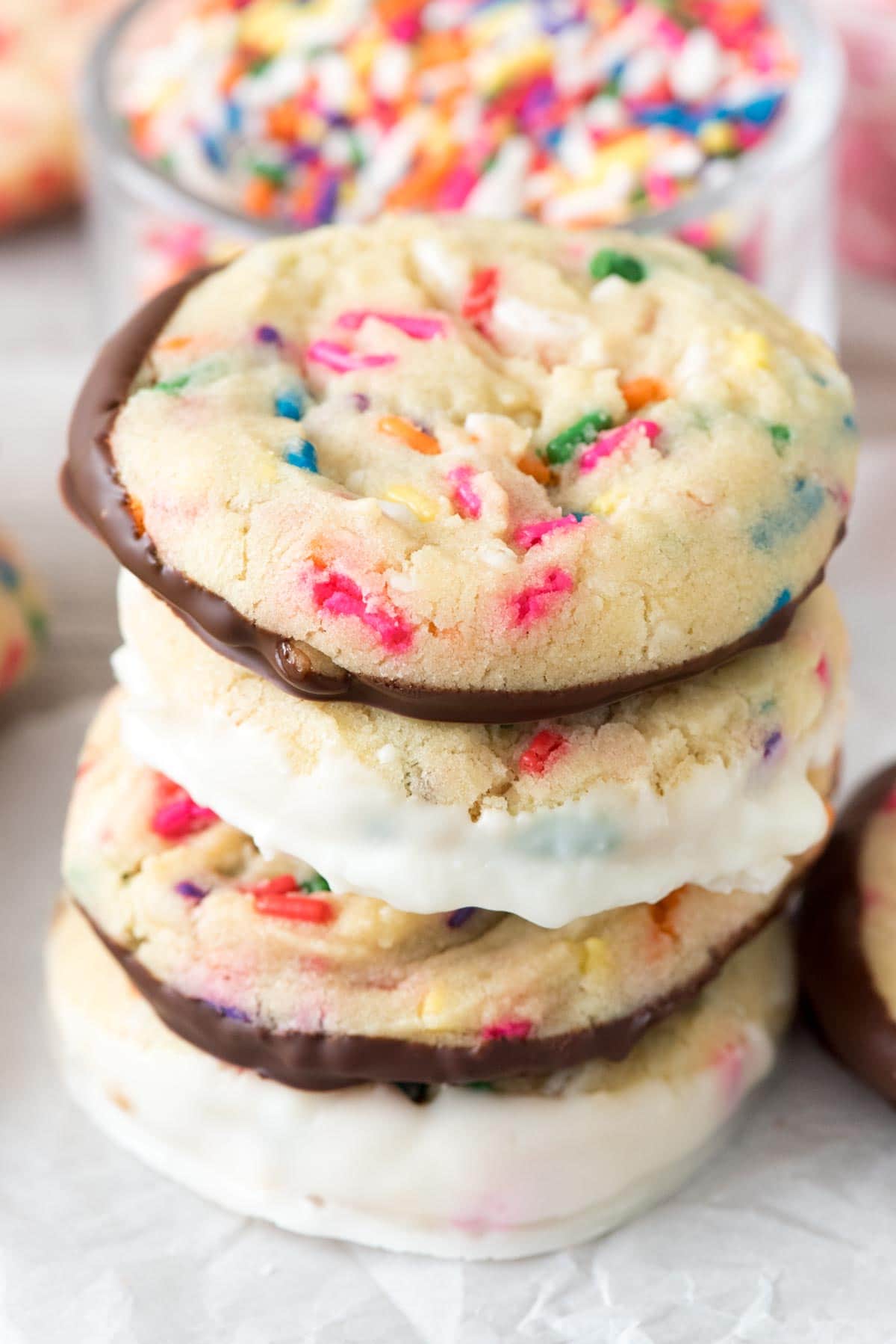 Sprinkle Cookies - this easy sugar cookie recipe is full of sprinkles! I love dipping the bottoms in chocolate for a sweet treat. EVERYONE loves these cookies!
