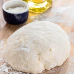 dough on cutting board still in a ball