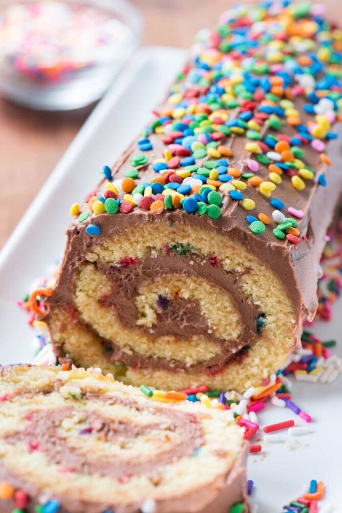 Birthday Cake Roll with one slice laying on its side