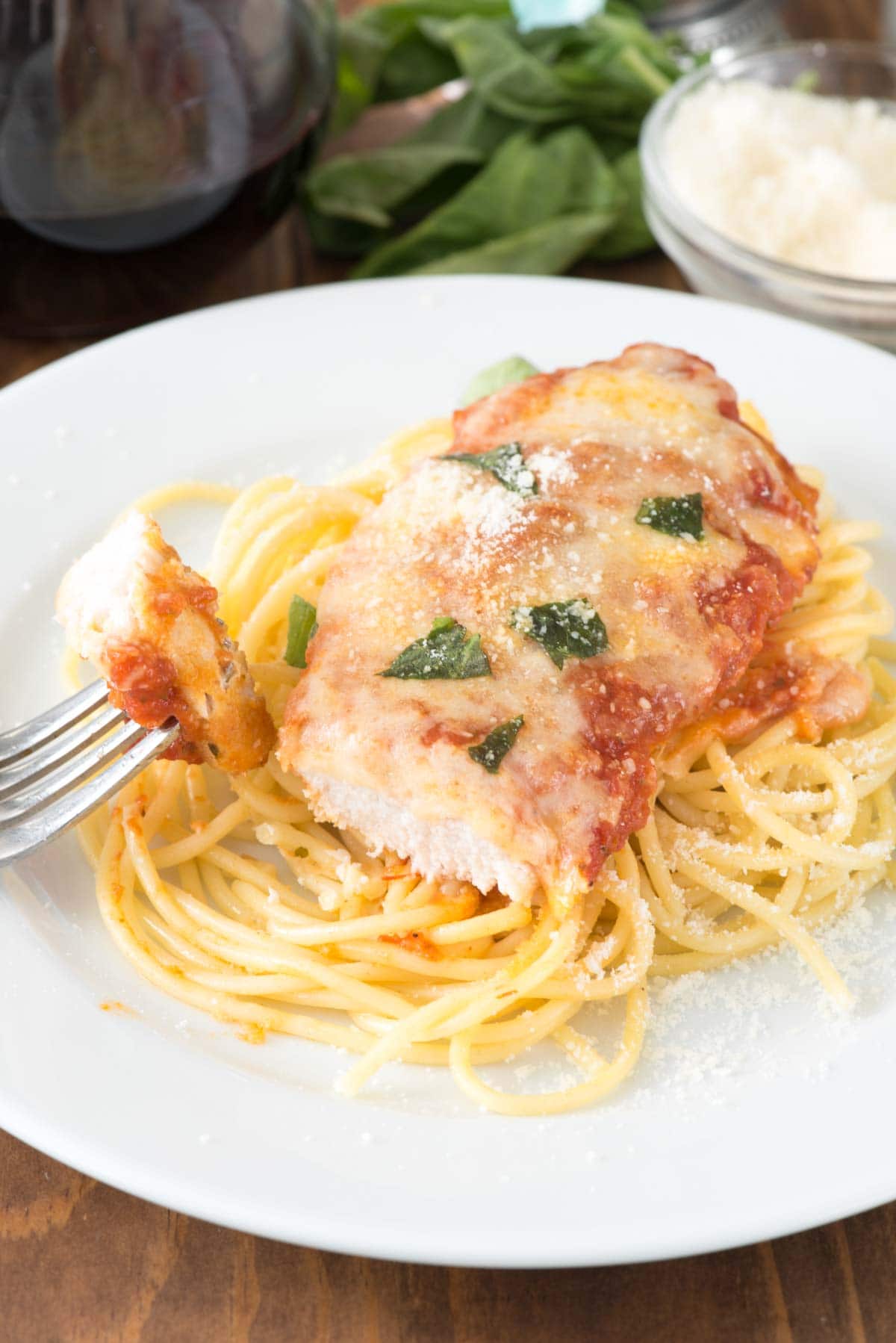 Easy Chicken Parmesan - this quick dinner recipe is totally foolproof. The chicken comes out moist every time! It's the BEST chicken parmesan recipe we've ever had.