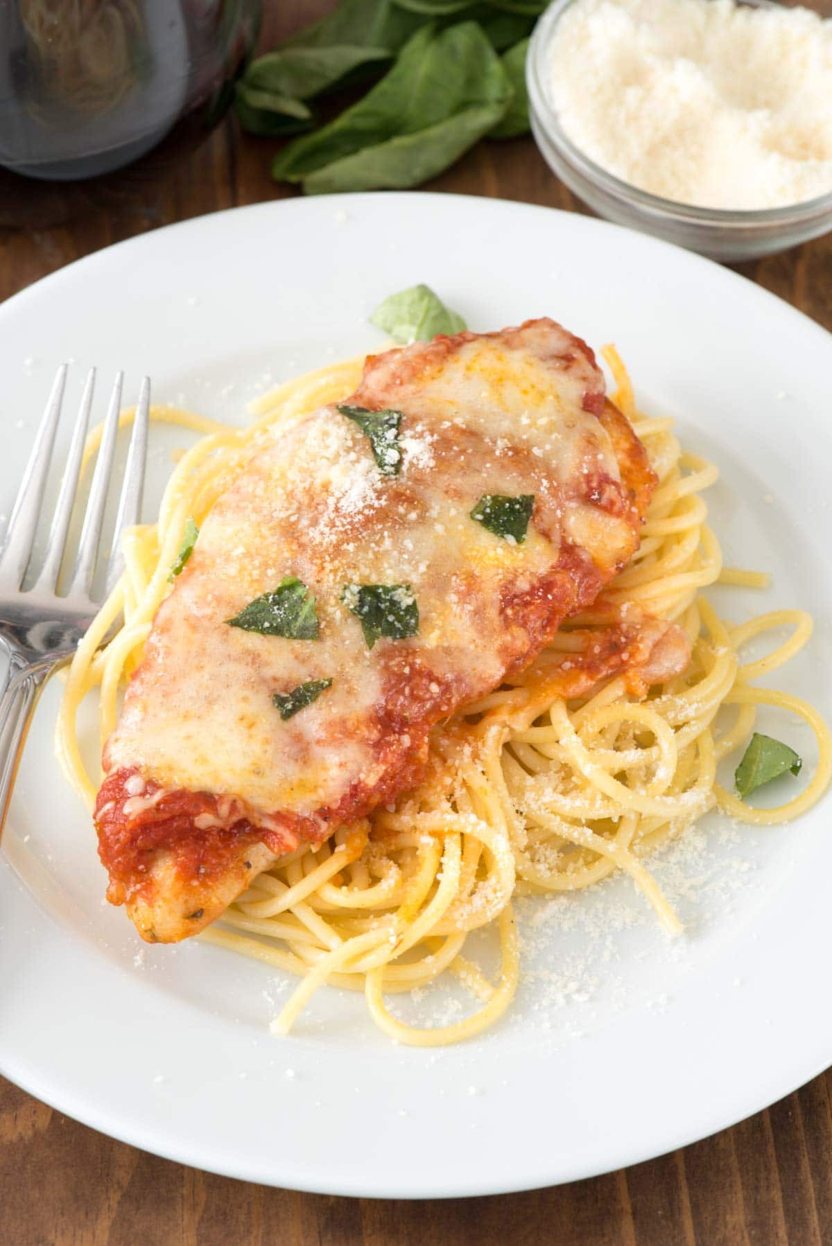 Easy Chicken Parmesan - this quick dinner recipe is totally foolproof. The chicken comes out moist every time! It's the BEST chicken parmesan recipe we've ever had.