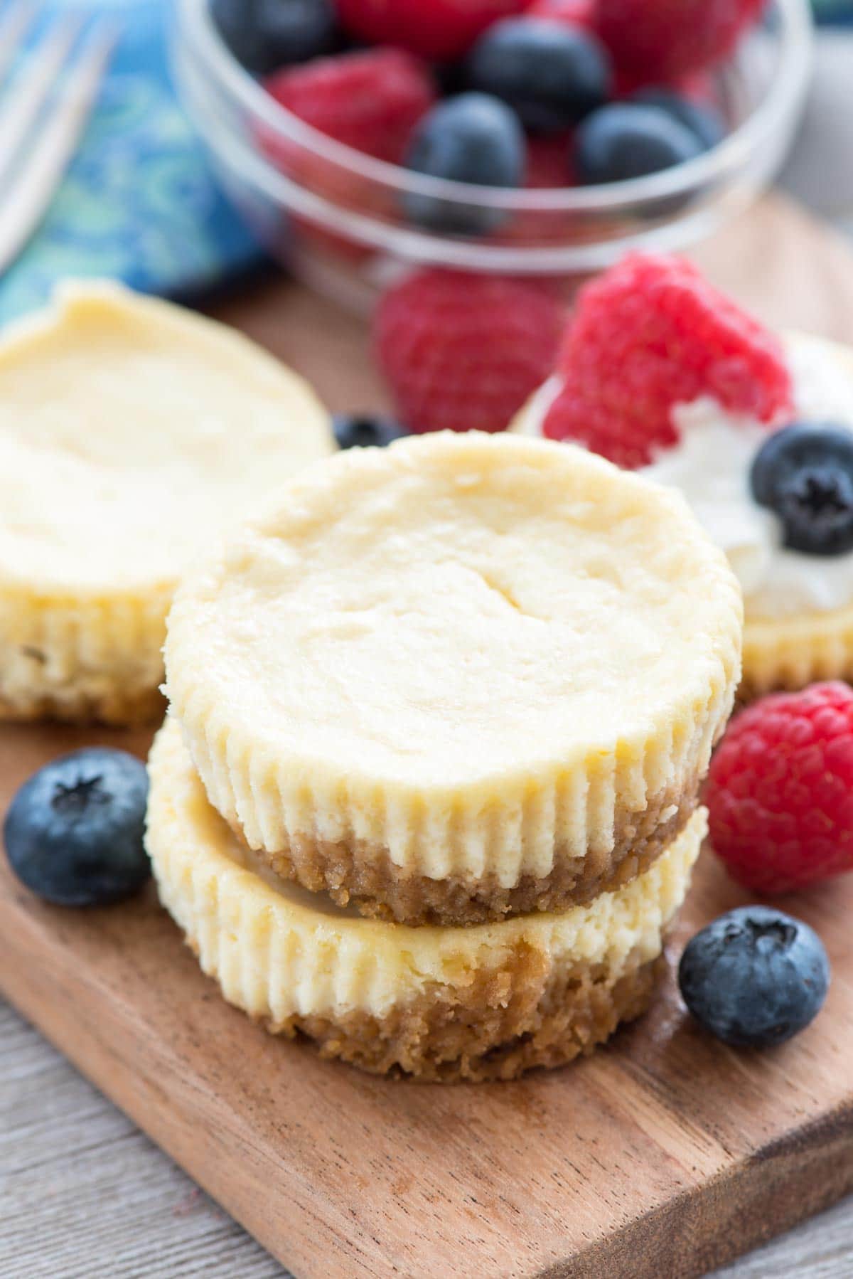 Easy Mini Cheesecake Recipe - this simple cheesecake recipe makes 12 perfect mini cheesecakes and can be made so many ways! Lemon, Oreo, S'mores, Fruit, Peanut Butter Cup - any cheesecake you want in no time at all.