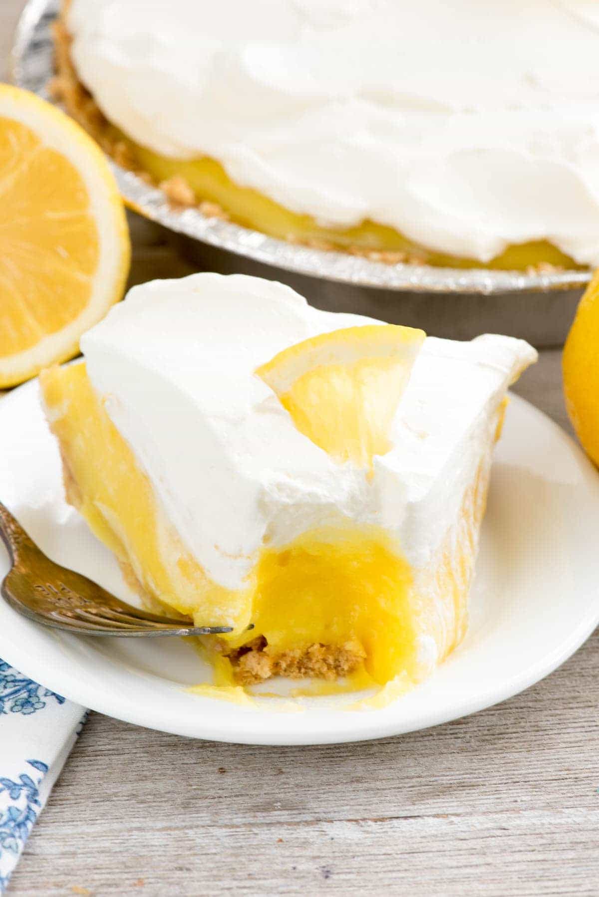 No Bake Lemon Cream Pie - this EASY lemon pie recipe has a homemade graham cracker crust and is filled with lemon and vanilla pudding! It's the EASIEST lemon pie recipe ever!