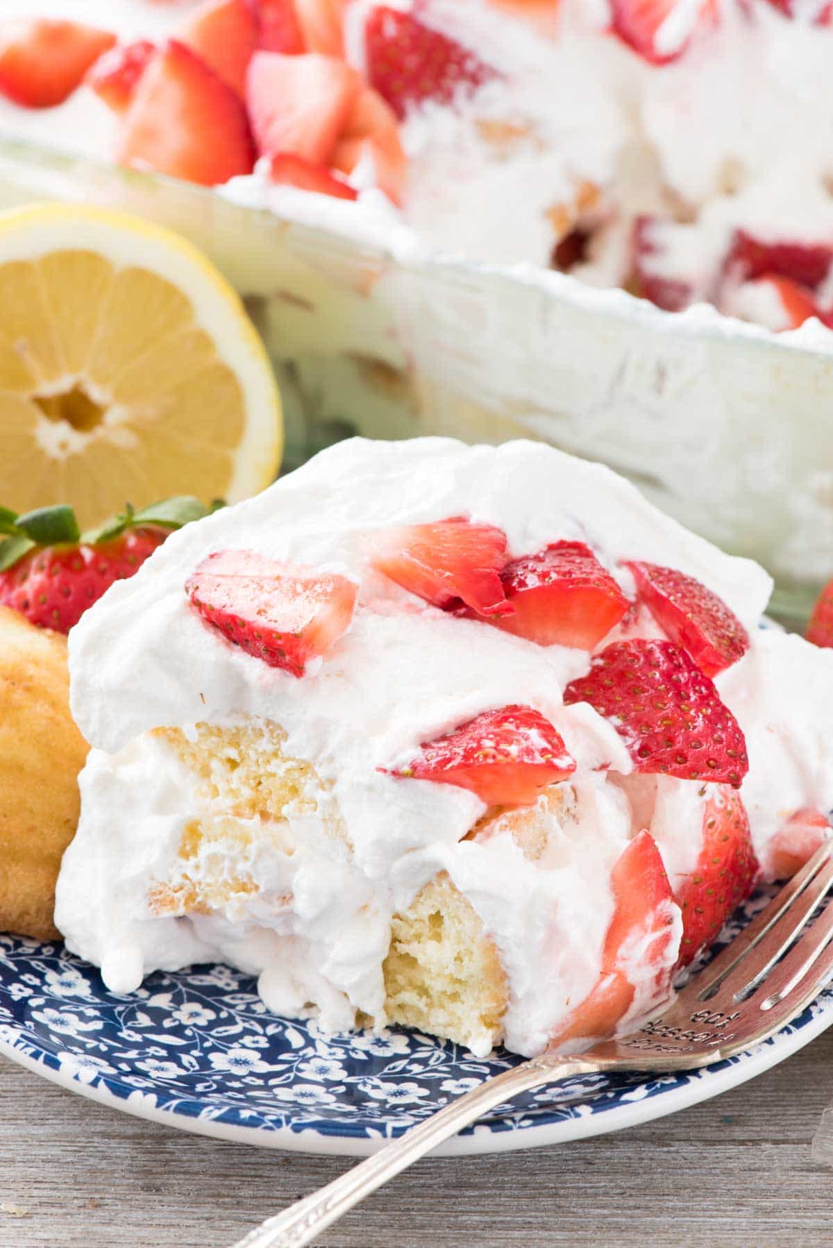 No Bake Strawberry Lemon Cake on a blue plate with a fork