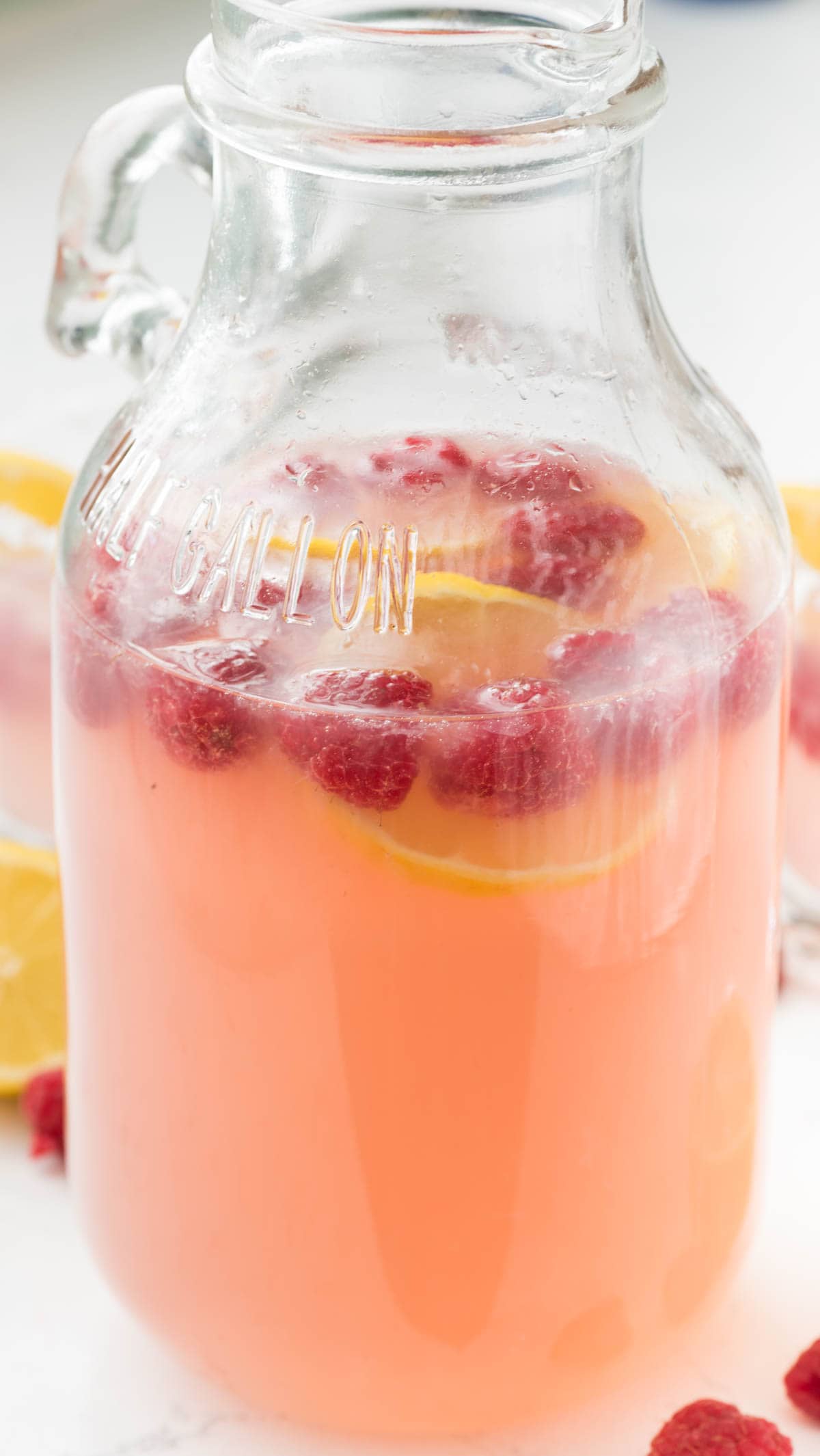 Raspberry Lemonade Margarita - this EASY cocktail recipe is the perfect margarita! Raspberry Lemonade, tequila, and triple sec- that's all it takes to make a pitcher!