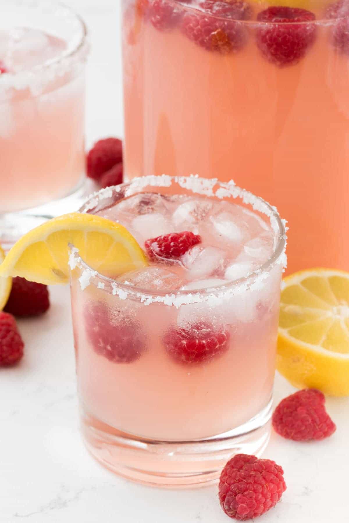 Raspberry Lemonade Margarita - this EASY cocktail recipe is the perfect margarita! Raspberry Lemonade, tequila, and triple sec- that's all it takes to make a pitcher!