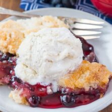 Easy Cherry Berry Dump Cake on a white plate with a fork