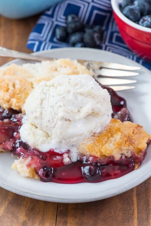 Easy Cherry Berry Dump Cake on a white plate with a fork