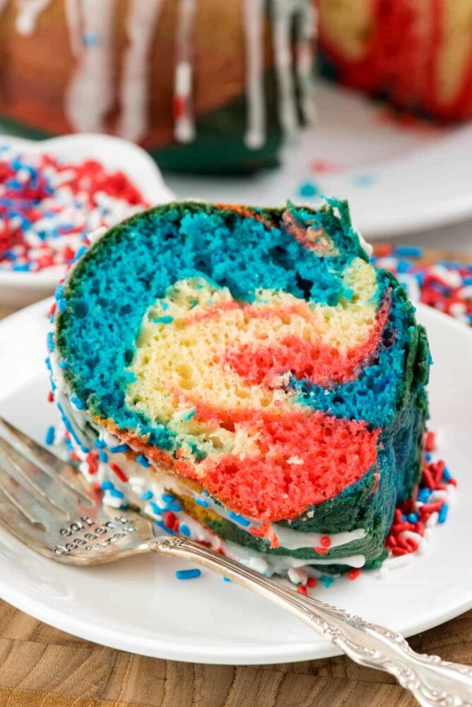 Slice of Fireworks Bundt cake on a white plate with a fork