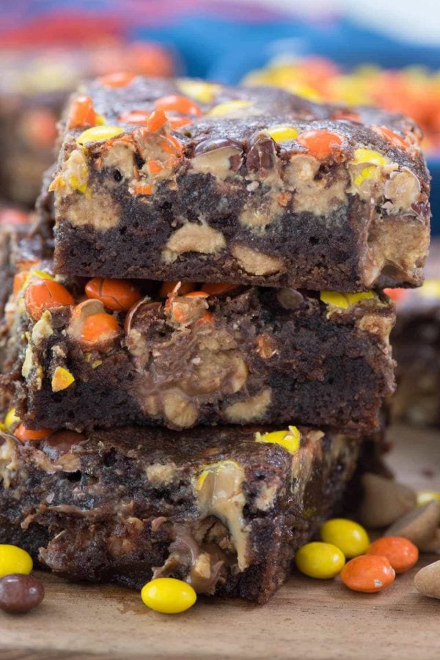 The ULTIMATE Reese's Brownies! This is a one bowl brownie recipe FULL of 3 KINDS of Reese's: peanut butter cups, peanut butter chips, and Reese's Pieces!!