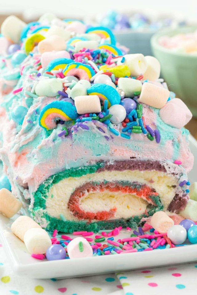 Unicorn Cake Roll with frosting, pudding whipped cream, sprinkles, marshmallows and all things glitter and fun.