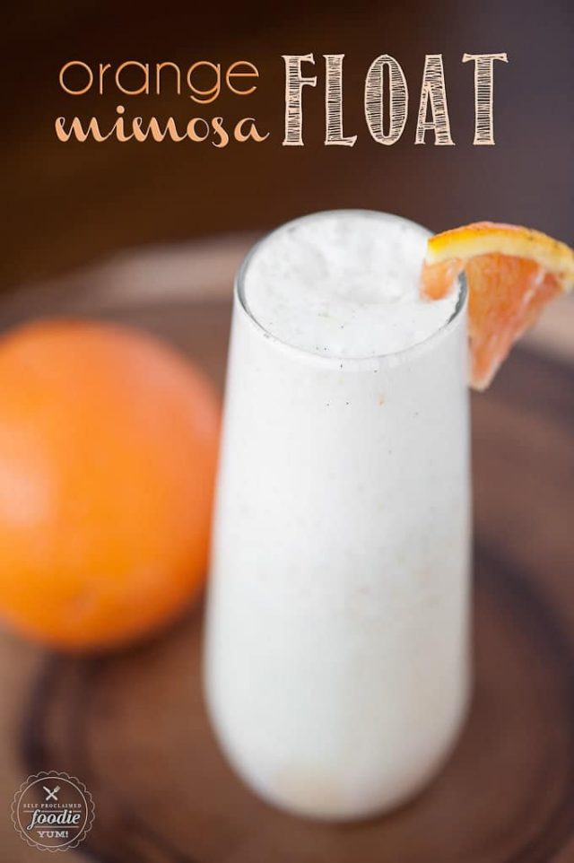 One glass of Orange Mimosa Float garnished with a sliced orange. 