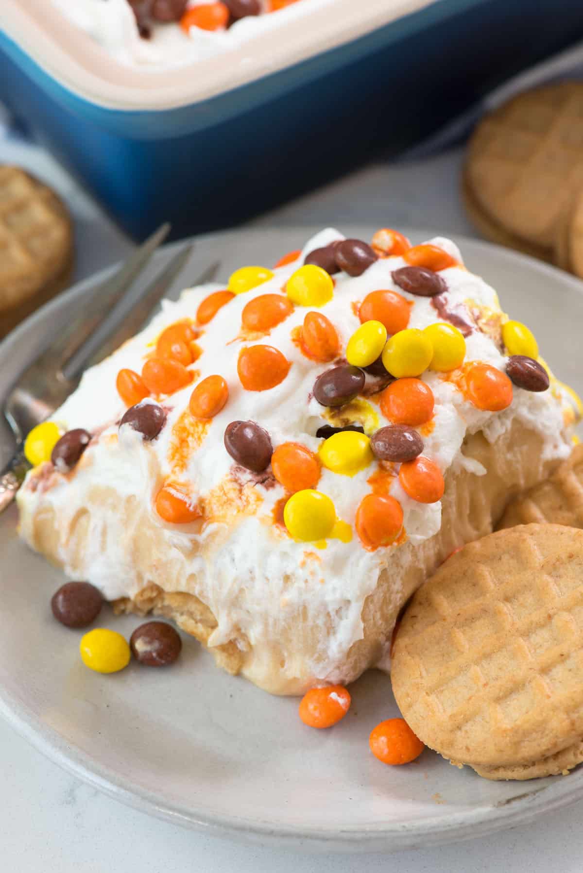 slice of icebox cake on plate with cookie.