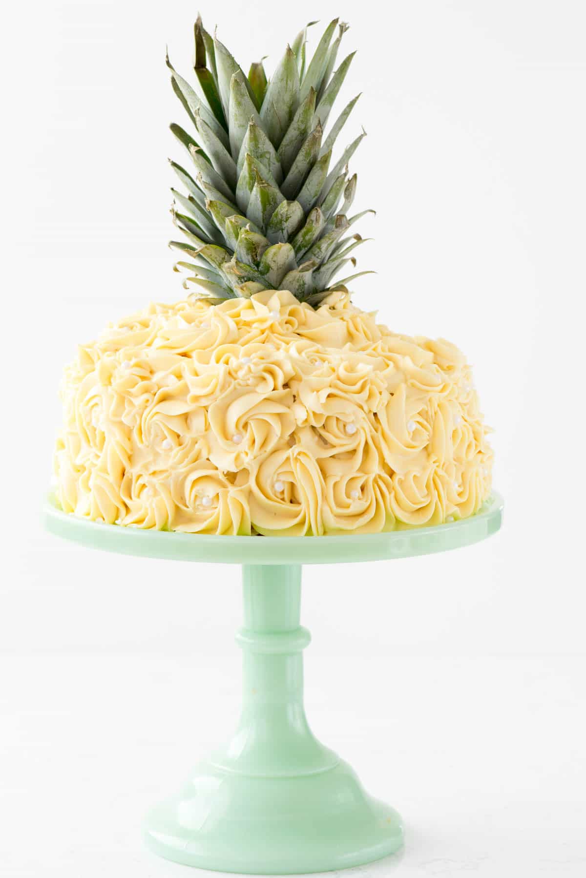 Pineapple Cake - this is the EASY way to make a pineapple cake for a pineapple party! Simply frost a 2-layer cake with yellow rosette swirls and you have a pineapple cake EASILY!