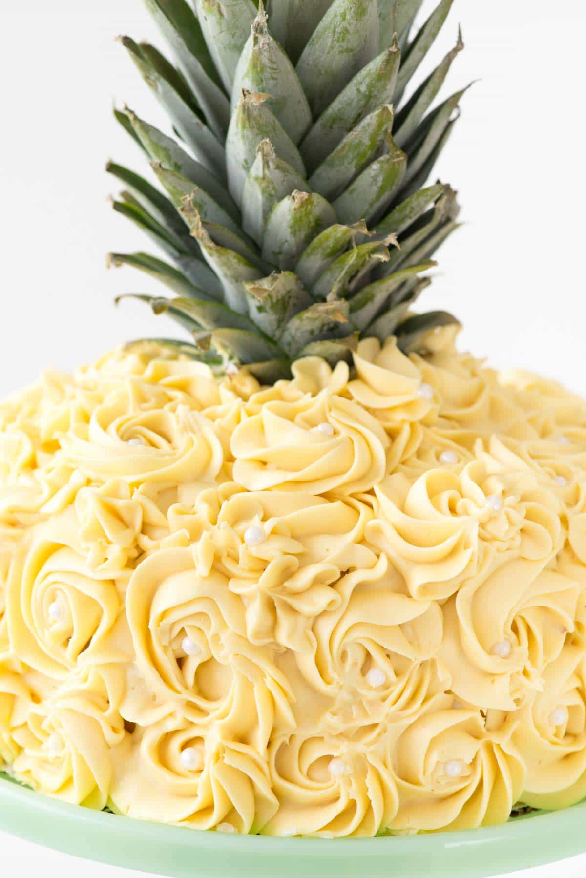 Pineapple Cake - this is the EASY way to make a pineapple cake for a pineapple party! Simply frost a 2-layer cake with yellow rosette swirls and you have a pineapple cake EASILY!