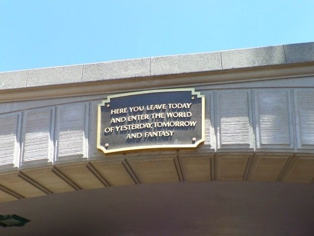 photo of the bridge at Disneyland with plaque "here you leave today and enter the world of yesterday tomorrow and fantasy"