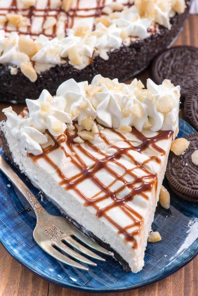 Slice of Macadamia Nut No Bake Cheesecake on a blue plate with a fork