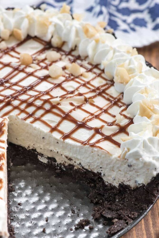 Cheesecake with slice missing The thick Oreo Macadamia Nut Crust on this no-bake cheesecake recipe is perfection!