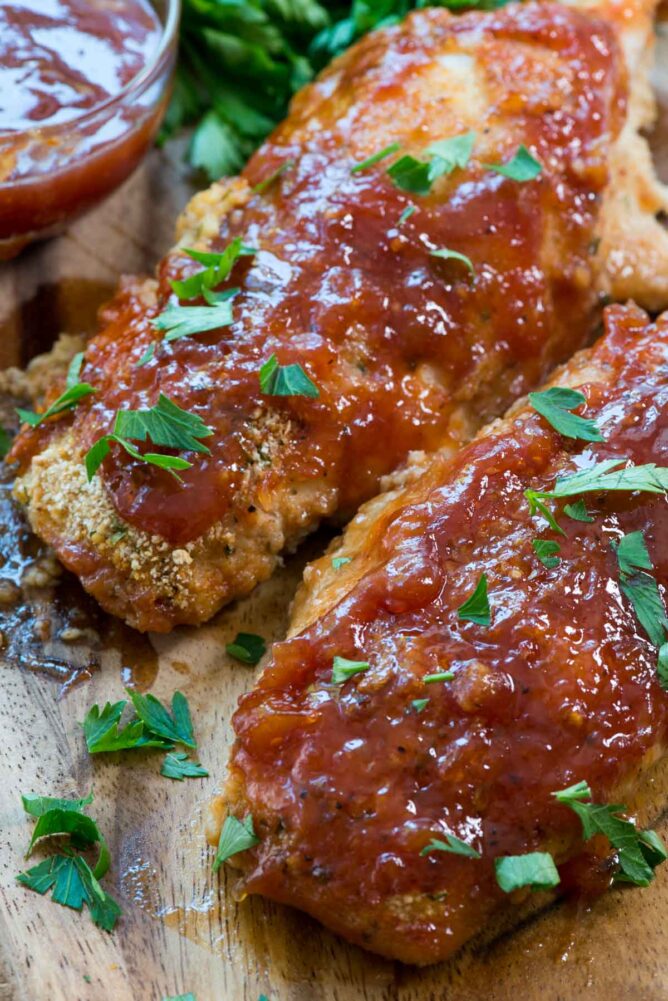 Easy Oven Baked BBQ Chicken on cutting board close up