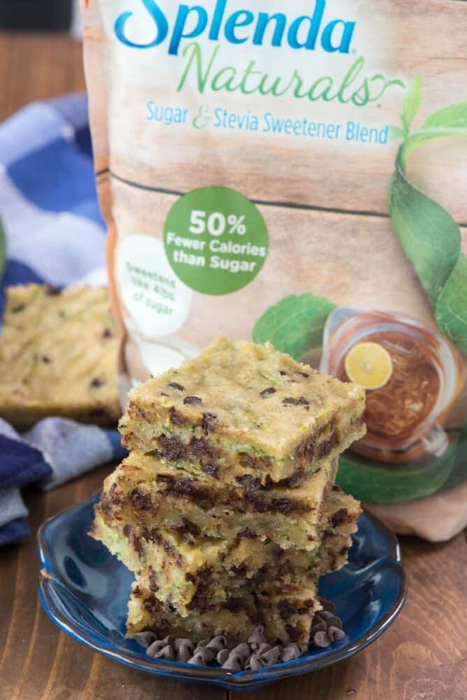 Easy one bowl chocolate chip zucchini bars in a stack on blue plate with splenda bag