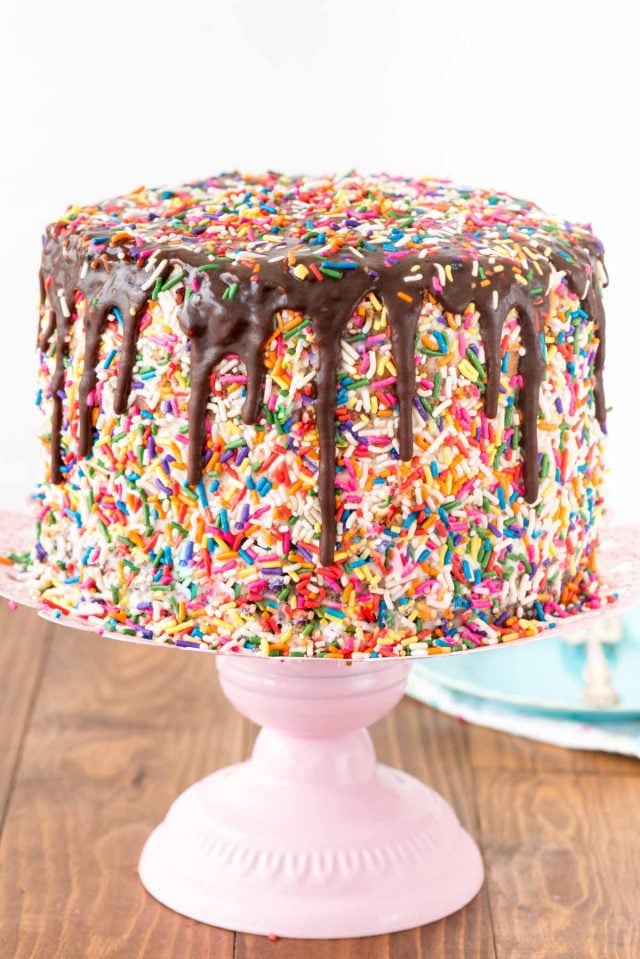 Funfetti Brownie Layer Cake - this cake is easier than it looks! There's a layer of brownie and two layers of confetti cake, filled with a cream cheese frosting and topped with a hot fudge chocolate drizzle! It's the PERFECT birthday cake recipe.