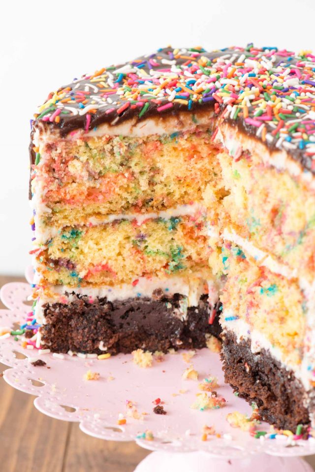 Funfetti Brownie Layer Cake - this cake is easier than it looks! There's a layer of brownie and two layers of confetti cake, filled with a cream cheese frosting and topped with a hot fudge chocolate drizzle! It's the PERFECT birthday cake recipe.