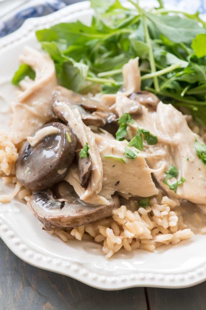 Chicken Mushroom on a white plate with some greens