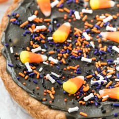 cookie cake with black frosting and halloween sprinkles