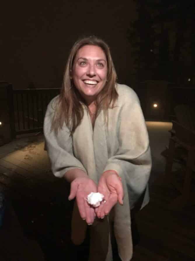 Picture of woman holding a snowball at night