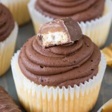 This easy cupcake recipe fills vanilla cupcakes with caramel and tops them with a chocolate ganache frosting like a Twix Candy Bar!