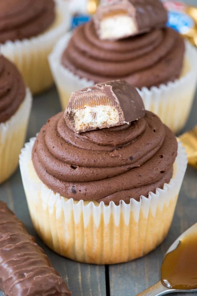 Easiest ever TWIX Cupcakes! This easy cupcake recipe fills vanilla cupcakes with caramel and tops them with a chocolate ganache frosting like a Twix Candy Bar!