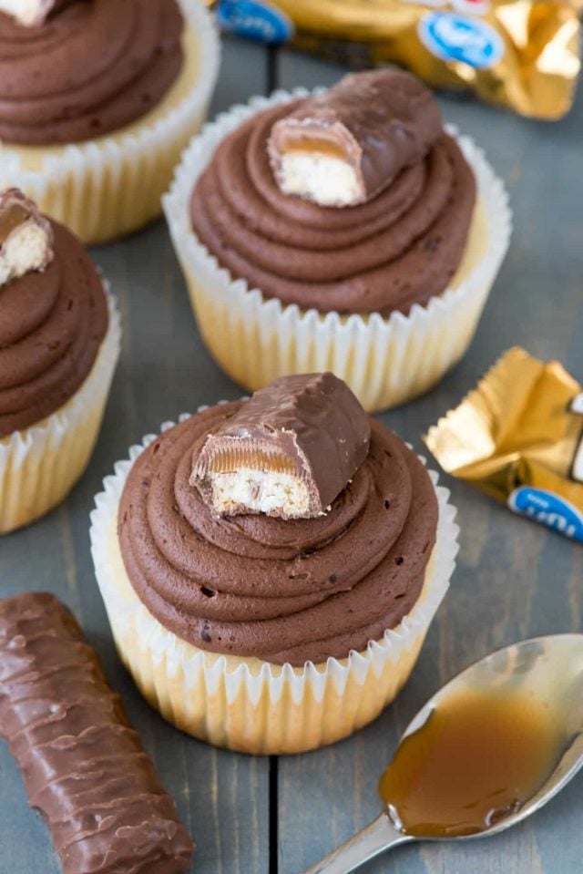 Easiest ever TWIX Cupcakes! This easy cupcake recipe fills vanilla cupcakes with caramel and tops them with a chocolate ganache frosting like a Twix Candy Bar!