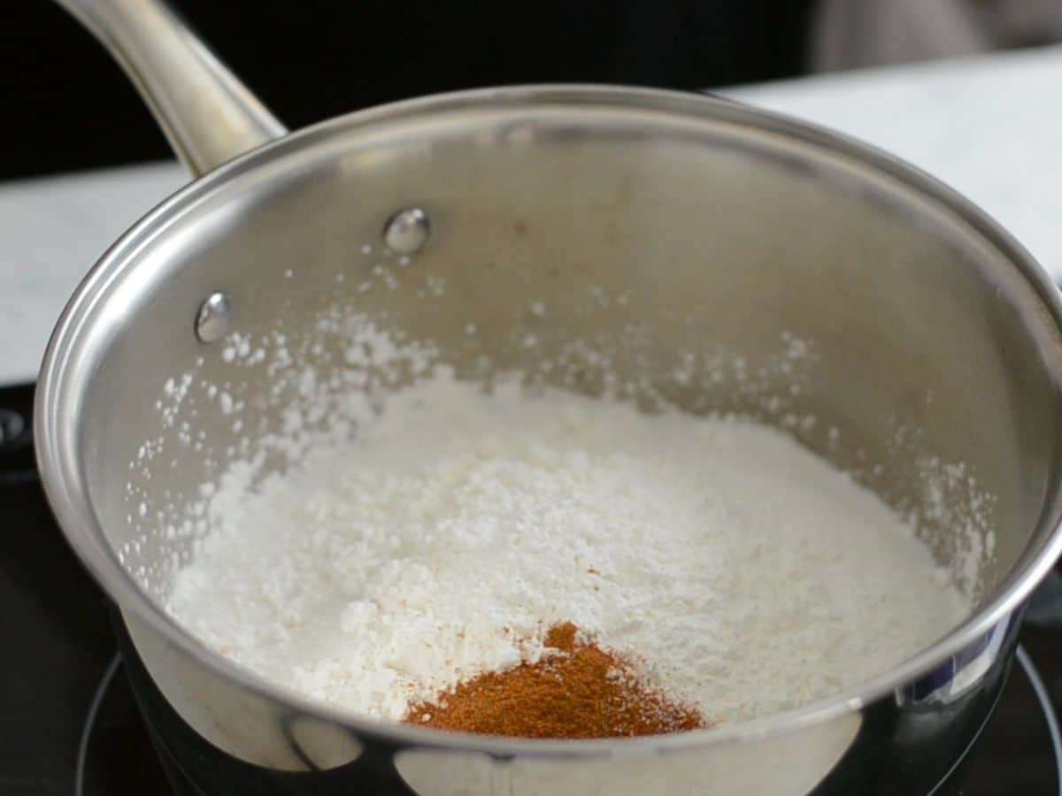 saucepan with powdered sugar, cornstarch, and cinnamon inside.