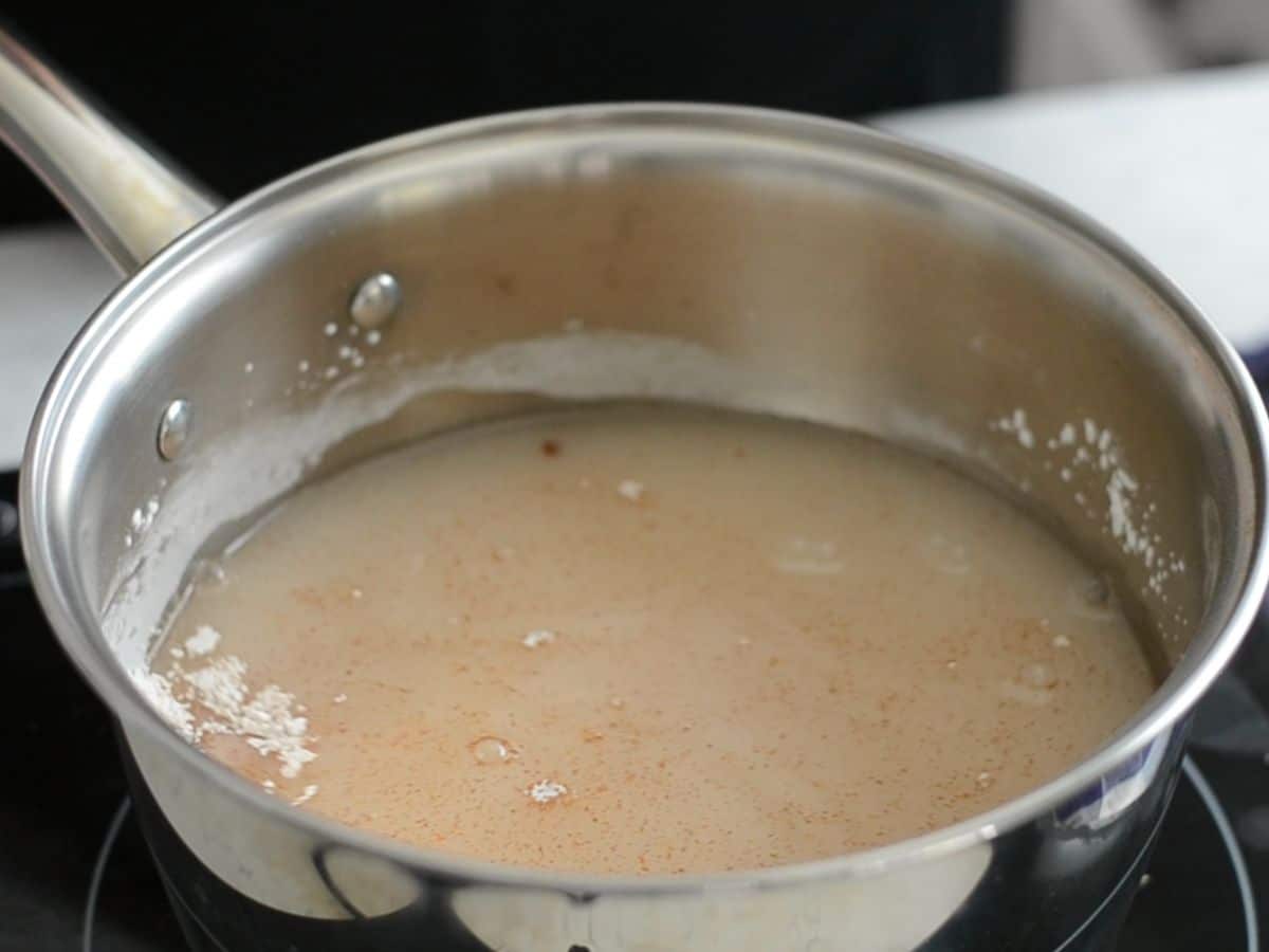 saucepan with water, powdered sugar, and cinnamon.