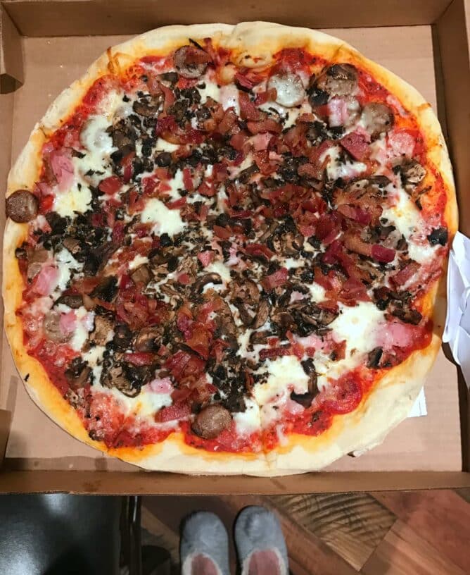 A large pizza sitting in a pizza box