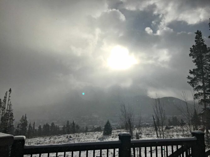 View from Cabin deck with snow on ground and sun coming through clouds